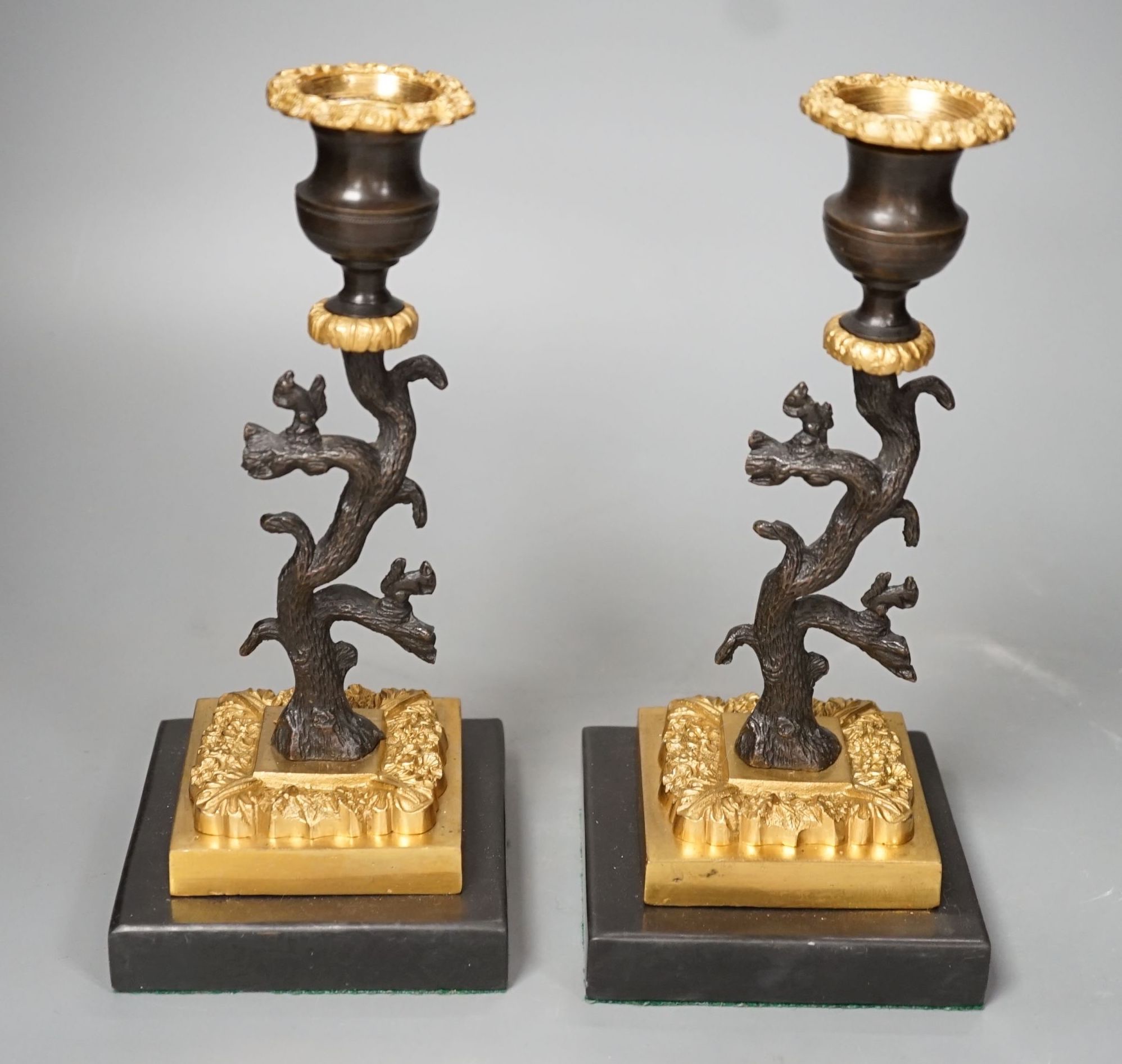 A pair of bronze and ormolu tree candlesticks - 22.5cm tall